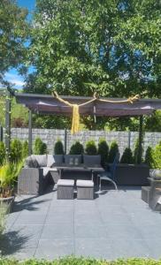 a patio with a picnic table and a canopy at Vacation home Moselsteg in Brauneberg +38 photos