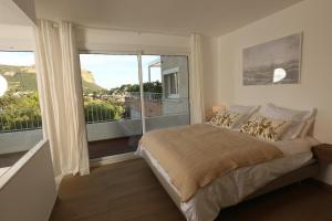 En eller flere senge i et værelse på Casa B- Splendid rooftop overlooking the sea