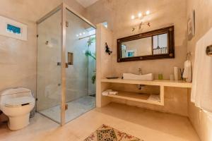 a bathroom with a shower and a toilet and a sink at Casa La Escondida in Mérida +12 photos