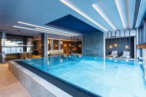 a large swimming pool in a hotel room at THE MATTHEW - pop up & down in Wagrain