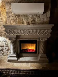 a stone fireplace with a fire place at Wish Cappadocia Love in Uçhisar