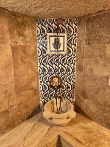 a room with a wall with a clock on it at Wish Cappadocia Love in Uçhisar