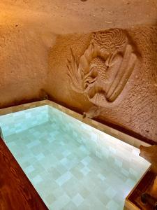 a bath tub with a lion on the side of a wall at Wish Cappadocia Love in Uçhisar +67 photos