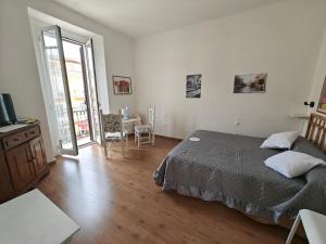 a bedroom with a bed and a television in it at Casa San Rocco in Fondi