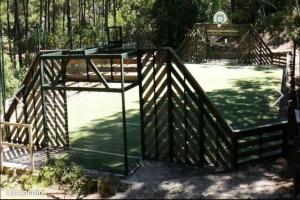 a wooden structure with a basketball hoop in a park at T2 32m2 terrasse 8m2 PISCINE LACANAU OCEAN LAC GOLF MULTISPORT in Lacanau