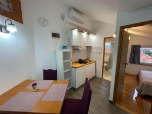 a kitchen and dining room with a table in a room at Villa Korčula in Vela Luka