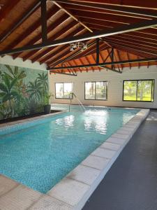 a large swimming pool in a building with a swimming pool at Náutico Apart Hotel in Chascomús