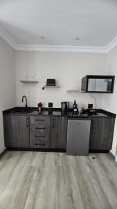 a kitchen with a wooden counter top in a room at Lavender Lofts in Centurion +21 photos