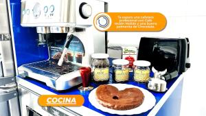 a coffee machine with a donut on a counter at La Casa Mágica in Burgos