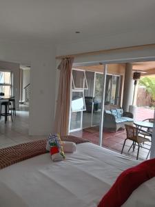 a large bed in a room with a patio at Harbour Close Home in Cape Town