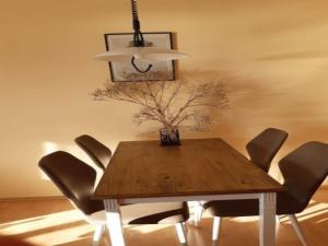 a dining room with a wooden table and chairs at Ferienanlage Orther Reede, Fehmarn-Orth in Orth
