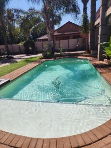 a swimming pool in the middle of a yard at Lavender Lofts in Centurion