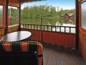 a room with a table and chairs and a large window at Bootshaus, Mirow in Mirow