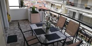 a balcony with a table and chairs on a balcony at Family Spacious Apartment Veria in Veria +32 photos