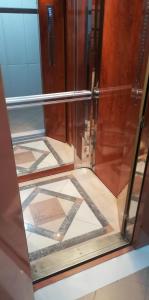 a glass display case with a tiled floor at Family Spacious Apartment Veria in Veria