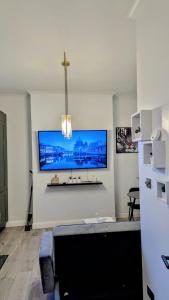 a living room with a flat screen tv on the wall at Crystal Palace Stylish gfloor 1bed apartment,3 minutes walk to Crystal palace station in London
