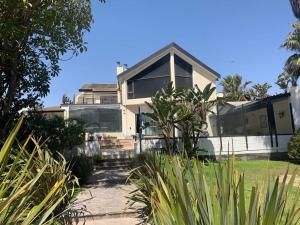 a house with a lot of plants in front of it at The Beach Residence in Swakopmund