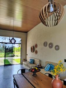a living room with a table and a couch at Casa Areia Bela - Patacho in Pôrto de Pedras