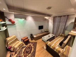 a living room with a bed and a couch at Nirvana Apartment Quiet Stay with Free Parking & Airport Access in Athens
