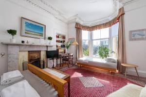 a living room with a fireplace and a couch at Sheens House in Edinburgh