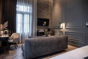 a living room with a couch and a table at Gagos Suites - Center in Larisa +25 photos