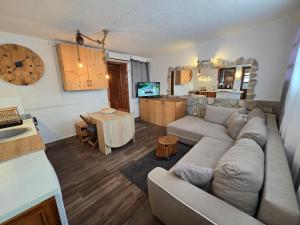 a living room with a couch and a kitchen at Jasmine Apartment in Herceg-Novi
