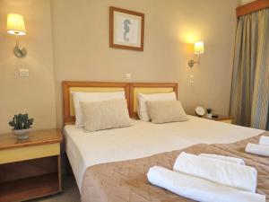 Postel nebo postele na pokoji v ubytování Koulouris Beach Hotel