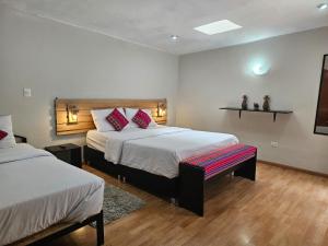 Ένα ή περισσότερα κρεβάτια σε δωμάτιο στο Xplora Hostel Cusco