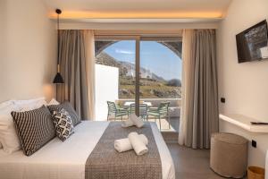 A bed or beds in a room at Depalyma Suites