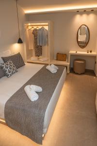 A bed or beds in a room at Depalyma Suites
