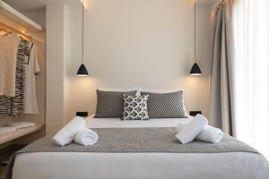 A bed or beds in a room at Depalyma Suites