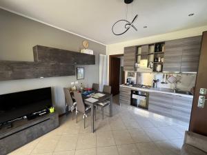 a kitchen with a table and a dining room at Alba sul Lago in Lenno