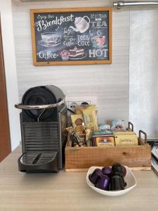 a kitchen counter with a coffee maker and a tray of food at Alba sul Lago in Lenno
