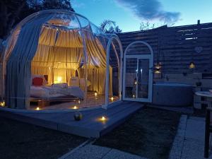 a dome house with a bed in it at night at Bulle insolite avec jacuzzi privé - Nature & romantisme a Fréjus in Fréjus