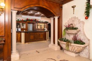 an entry way with a kitchen with a planter at Festa Winter Palace Hotel in Borovets