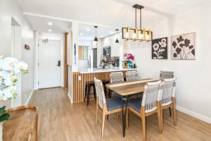 a kitchen and dining room with a table and chairs at Oceanfront Modern & Elegant Vistas in Kihei +60 photos