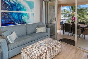 a living room with a couch and a table at Oceanfront Modern & Elegant Vistas in Kihei