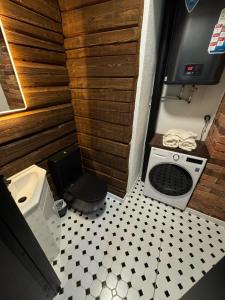 a small bathroom with a toilet and a sink at Cozy Stay - Self Check-In, Free Parking in Tartu