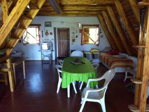 a living room with a table and a bed at Bungalow San Antonio in San Antonio de Arredondo +8 photos
