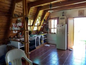 a kitchen with a refrigerator and a stove at Bungalow San Antonio in San Antonio de Arredondo