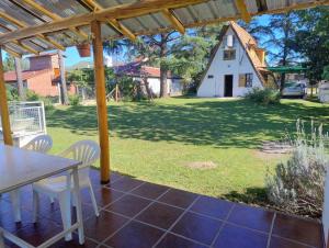 a patio with a table and chairs and a barn at Bungalow San Antonio in San Antonio de Arredondo