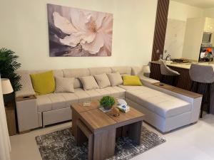 a living room with a couch and a coffee table at Apartment at Marassi in El Alamein