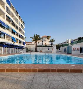 a large swimming pool in front of a building at Yumbo Tinache Luxury Maspalomas in Maspalomas