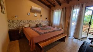a bedroom with a bed and a large window at Hotel Hacienda Angeles in Paraíso +75 photos