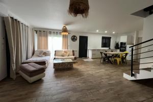 a living room with a couch and a table at Maison neuve 4 chambre avec jacuzzi in Les-Pennes-Mirabeau