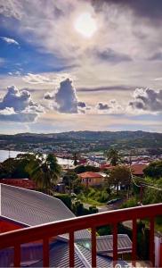 a view of a city from the balcony of a house at Grandvistasuites Tobago in Scarborough