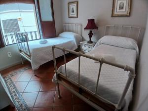 a bedroom with two beds and a window at Budget and lovely rooms Macarena B in Seville +29 photos