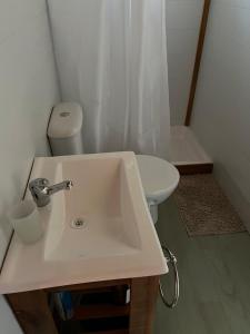 a bathroom with a sink and a toilet at Complejo de cabañas El Mangrullo in Larroque +49 photos
