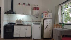 a kitchen with two refrigerators and a refrigerator at Monoambiente in Morón