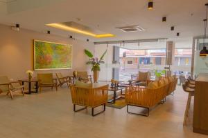 a restaurant with chairs and tables and a painting on the wall at VVC Hotel's in Villavicencio